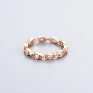Detail of rose gold ring featuring marquise links with pavé milgrain and round zircons