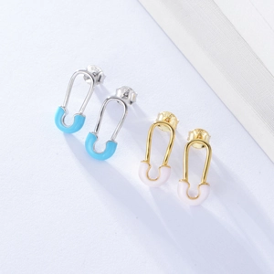 Macro detail of S925 sterling silver paperclip earrings with pink and blue enamel