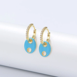 Detailed close-up of 925 stamp on gold-plated hoop earrings with blue enamel pendant