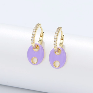 Macro view of S925 silver gold-plated hoop earrings with purple enamel and zircons