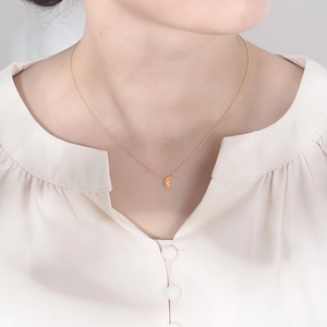 Minimalist S925 silver moon necklace with orange enamel and sparkling zircon detail