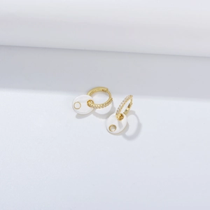 Detailed close-up of 925 sterling silver pig nose earring with white enamel and zircons