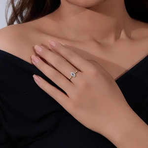 Macro detail of sky blue topaz ring with marquise cut stone and gold band set with zircon
