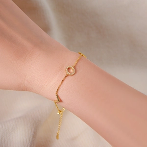 Gold LOVE letter bracelet with shimmering zircon pavé circle on delicate chain