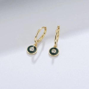 Macro detail of S925 sterling silver stamp on green enamel hoop earrings with zircon