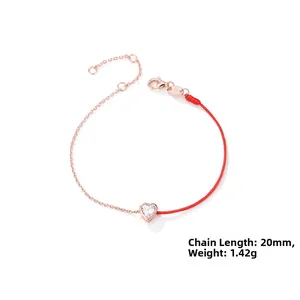Macro detail of S925 sterling silver stamp and heart-shaped cubic zirconia red rope bracelet