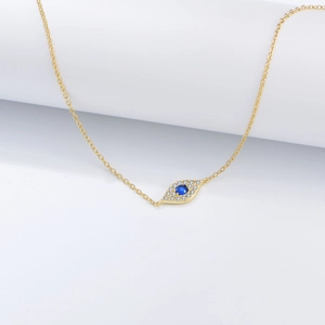Macro shot of s925 silver evil eye pendant with pavé zircons and a deep blue gemstone