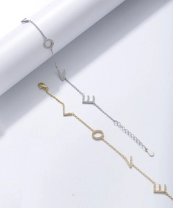 Detailed close-up of gold and silver LOVE letter bracelets with shimmering zircon stones
