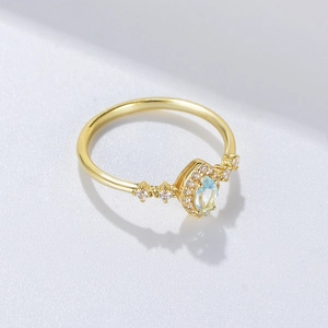 Elegant S925 silver gold-plated ring with oval sky blue topaz and halo zircon accents