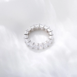 Vue détaillée d'une bague éternité en argent avec zircons carrés sur soie blanche