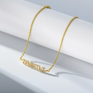 Detailed close-up of golden S925 silver bracelet with micro-pave zircon MAMA pendant