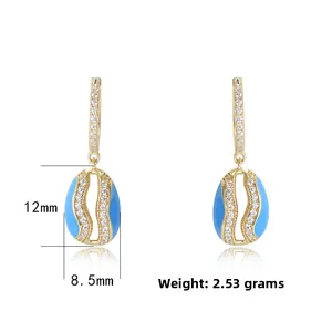 Detail view of oval blue enamel earrings with dimensions 12mm x 8.5mm and 2.53g weight