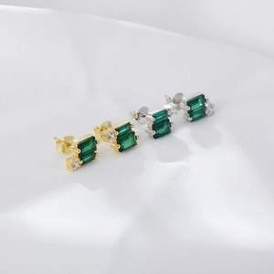 Geometric emerald zircon stud earrings set in polished gold and silver finishes
