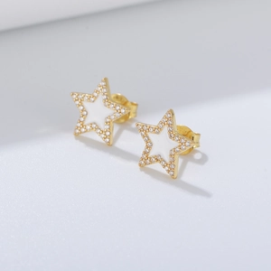 Macro detail of S925 silver star stud earrings with pavé zircons and white enamel