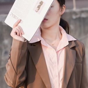 Close-up of minimalist gold hollow heart pendant necklace on female model neck