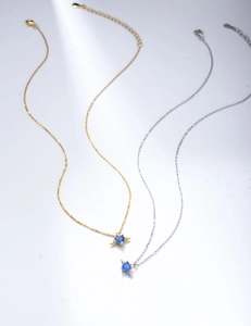 Detail of s925 silver angel wing pendant necklaces with blue heart-shaped cubic zirconia