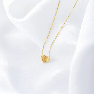 Minimalist S925 sterling silver hollow heart necklace with polished gold finish on silk