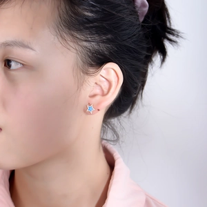 Asian model wearing S925 sterling silver star stud earrings with blue enamel and zircon