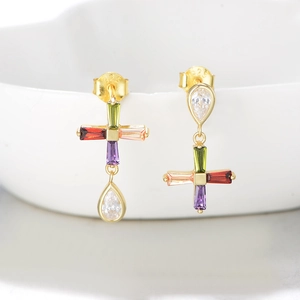 Detail of S925 sterling silver stamp on asymmetrical cross earrings with colorful zircons
