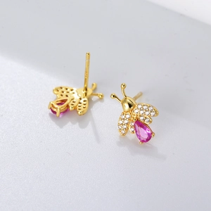 Detailed macro view of S925 sterling silver bee stud earrings with pink zircon stone
