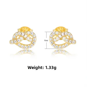 Detailed macro view of S925 silver knot stud earrings with pave-set zircons and 925 hallmark