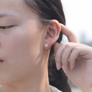 Elegant s925 silver snowflake earrings with sparkling zircons worn by a female model