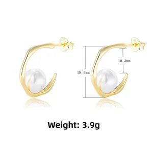 Detail view of gold C-shape silver earrings with pearl and S925 hallmark stamp