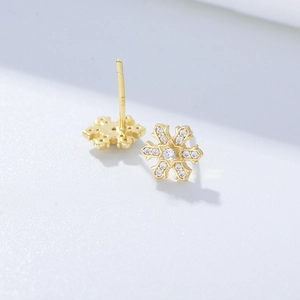Detailed macro view of S925 sterling silver snowflake earrings with sparkling zirconia