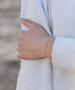 Close-up of minimalist gold S925 sterling silver chain bracelet with pavé bar and round diamond