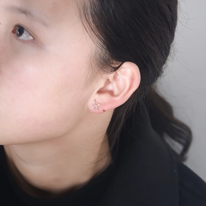 Elegant 925 silver flower stud earrings with pink zircon stones worn on the ear