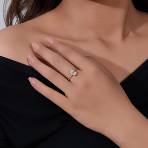 Detailed close-up of an emerald-cut zircon set in a minimalist gold-plated silver ring