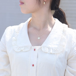 Elegant gold octagram square pendant necklace and teardrop earrings set on a model