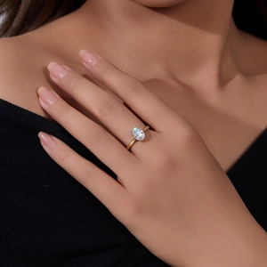 Close-up of elegant gold s925 silver ring featuring a sparkling oval cut solitaire diamond