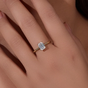 Elegant gold S925 silver ring with rectangle emerald-cut zircon on female hand
