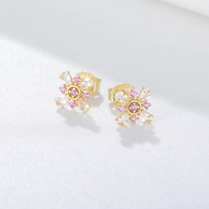 Macro shot of S925 sterling silver flower stud earrings with pink zircon stone details