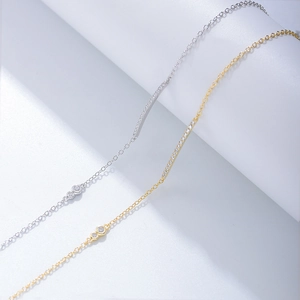 Macro detail of fine s925 silver and gold chains with micro-set zircon bar accents