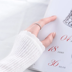 Close-up of a s925 silver minimalist ring with micro-pave zircons on a model's finger