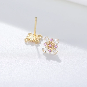 Macro shot of 925 silver stud earrings with pink and clear zircon flower petals