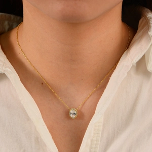 Elegant gold plated s925 silver necklace with oval zircon halo pendant on woman's neck