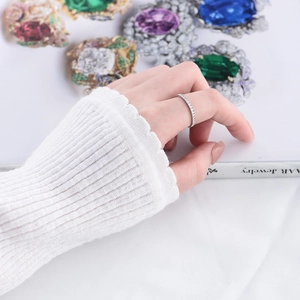 Close-up of minimalist S925 silver ring with micro-pave cubic zirconia worn by a model