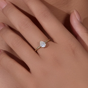 Elegant pear-cut cubic zirconia ring in gold finish on a model hand