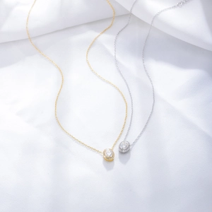 Elegant S925 sterling silver necklaces with oval cut zircon pendants on silk background