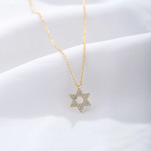 Macro view of gold s925 silver hexagram pendant necklace with micro-set zircons