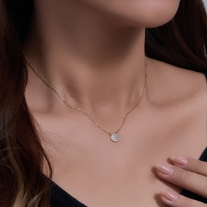 Macro shot of 925 sterling silver gold-plated necklace with pavé-set round pendant