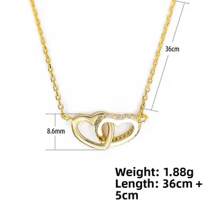 Detailed view of interconnected gold heart pendants with shimmering zircon stones and fine chain
