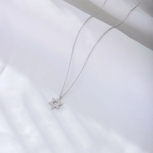 Sparkling S925 sterling silver hexagram pendant necklace on elegant white fabric
