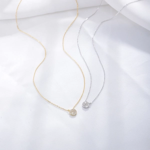 Close-up of minimalist S925 sterling silver pave-set round zircon pendant necklaces in gold and silver