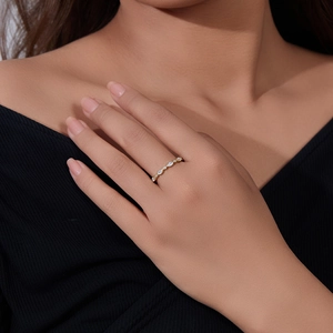 Detail of s925 silver gold ring with marquise cut zircons on a model's finger