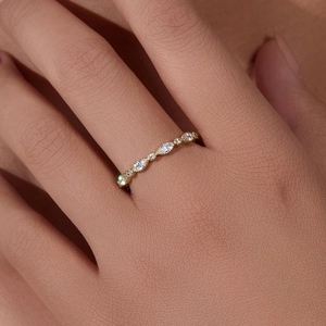 Close-up of gold s925 silver ring with marquise and round cut crystals on finger