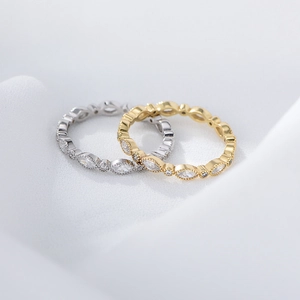 Close-up of stacked S925 sterling silver and gold marquise-cut diamond rings